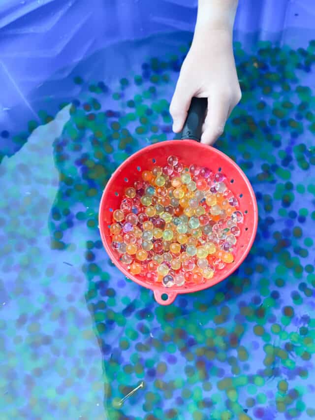 water beads in a red colander