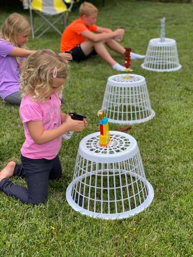 kids spraying down the LEGO towers with water