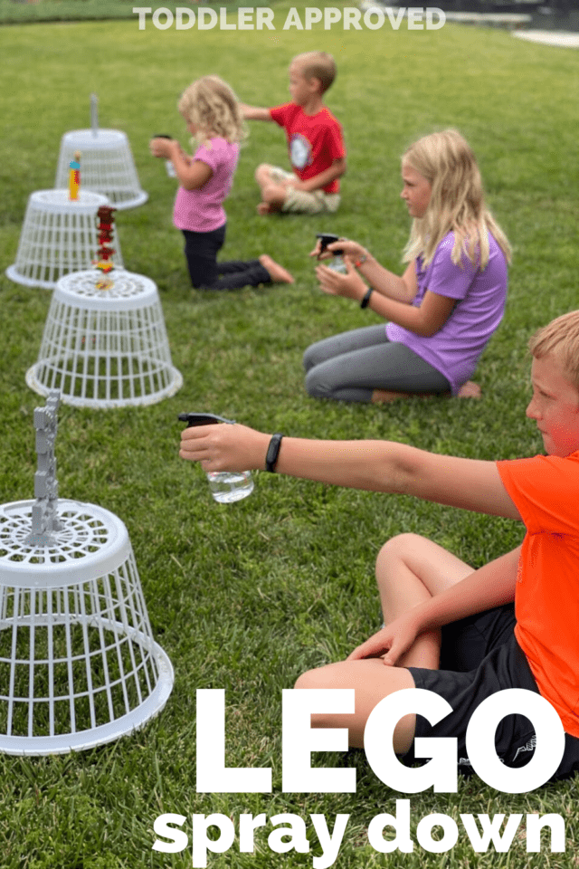 four kids spraying down LEGO towers with spray bottles