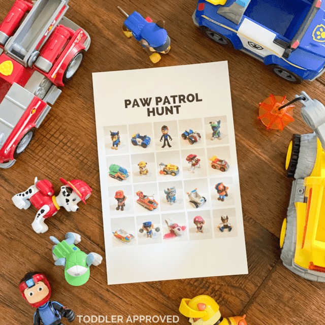 Paw Patrol toys on the floor along with a paper that has Paw Patrol photos on it.